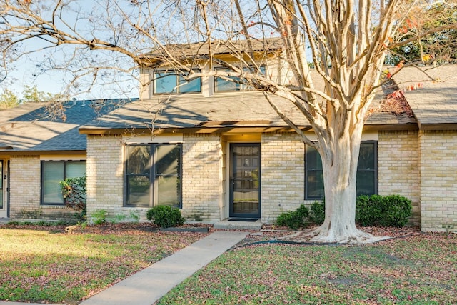 8233 Summer Side Dr Unit 172, Austin, TX 78759 - view of front of house with brick siding, a front yard, and a shingled roof