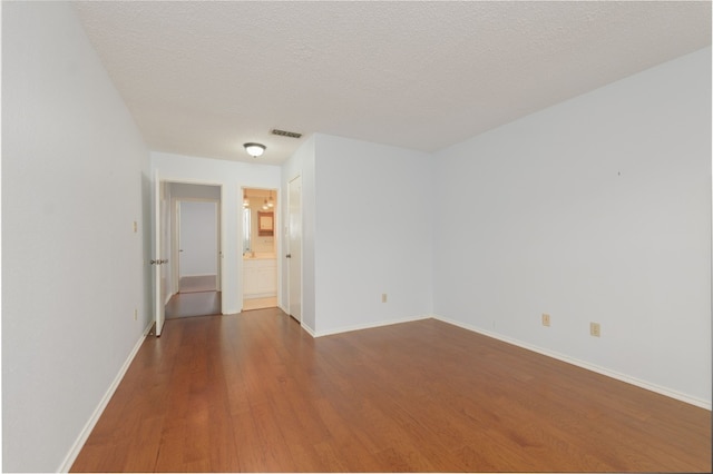 8233 Summer Side Dr Unit 172, Austin, TX 78759 - unfurnished room with wood finished floors and a textured ceiling