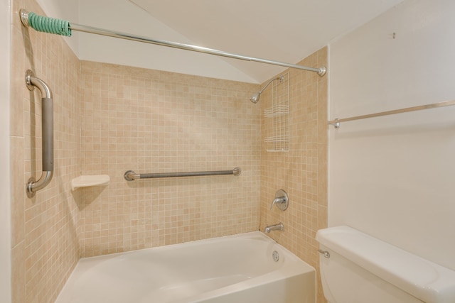 bathroom featuring toilet and tiled shower / bath