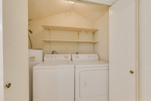 laundry room featuring independent washer and dryer, a textured ceiling, and water heater