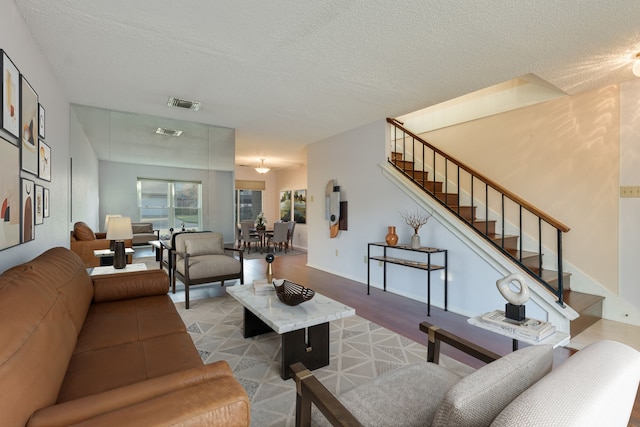 living room with a textured ceiling and hardwood / wood-style flooring