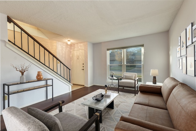 living room featuring a textured ceiling and light wood-type flooring