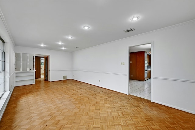 spare room featuring light parquet flooring and ornamental molding