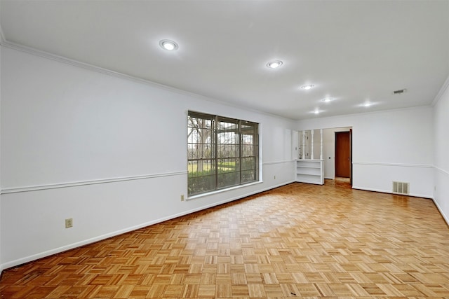 spare room featuring light parquet floors and crown molding