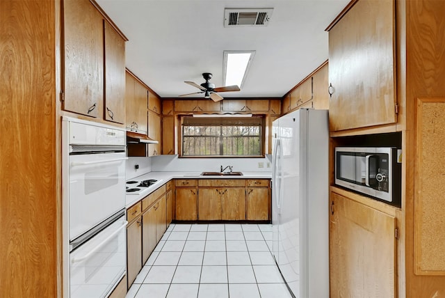 kitchen with sink, white appliances, ceiling fan, and light tile patterned flooring