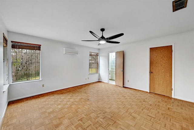 4204 Gregg Ward Ln, Austin, TX 78744 - unfurnished bedroom with a wall unit AC, multiple windows, ensuite bath, and a ceiling fan