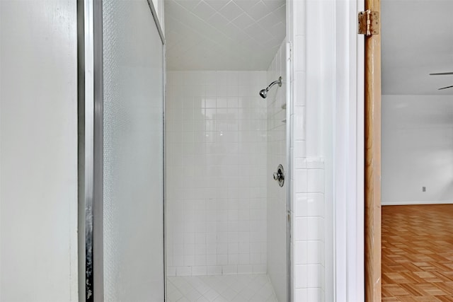 bathroom with parquet floors and walk in shower