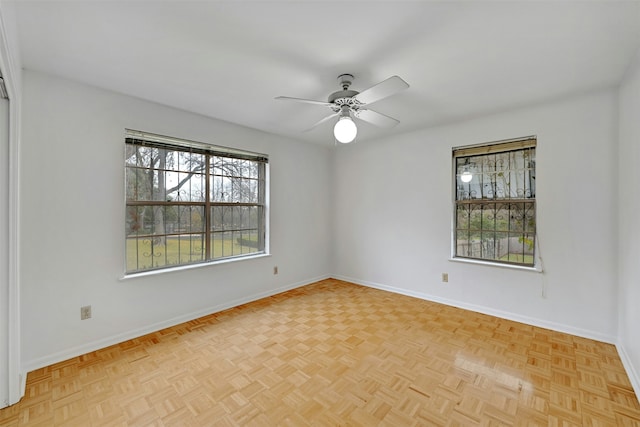 unfurnished room featuring ceiling fan and light parquet floors