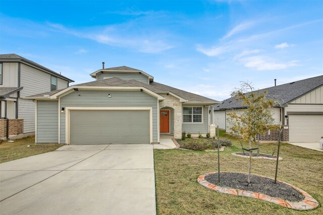 view of front of home featuring a front yard and a garage