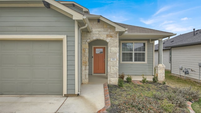 view of front of house featuring an attached garage, stone siding, concrete driveway, and roof with shingles