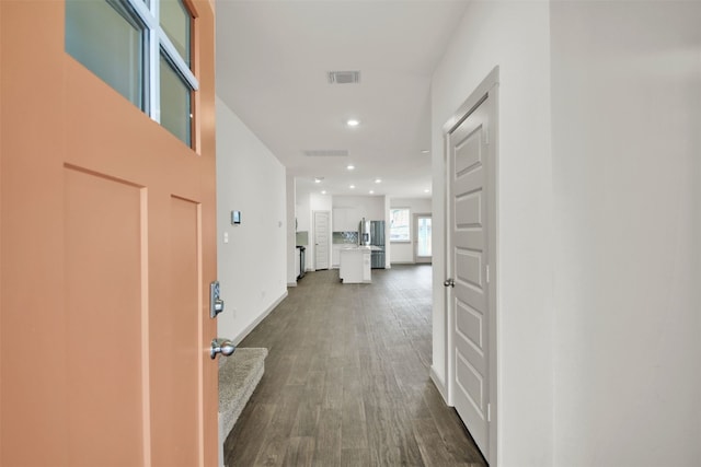 hallway with recessed lighting, visible vents, dark wood finished floors, and baseboards