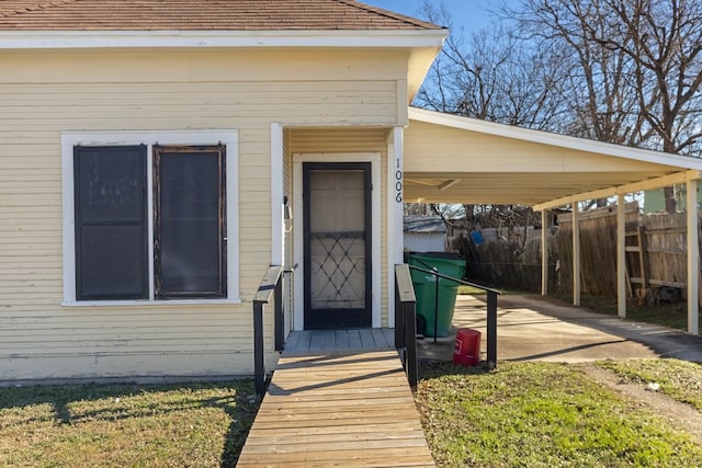 doorway to property with a carport