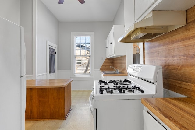 kitchen featuring white cabinetry, sink, ceiling fan, and white appliances