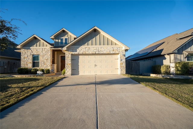 view of front of house with a garage and a front lawn