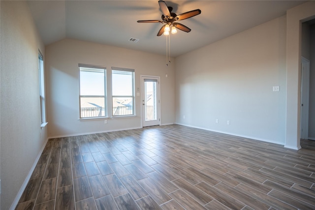 spare room featuring dark wood-type flooring, ceiling fan, and vaulted ceiling