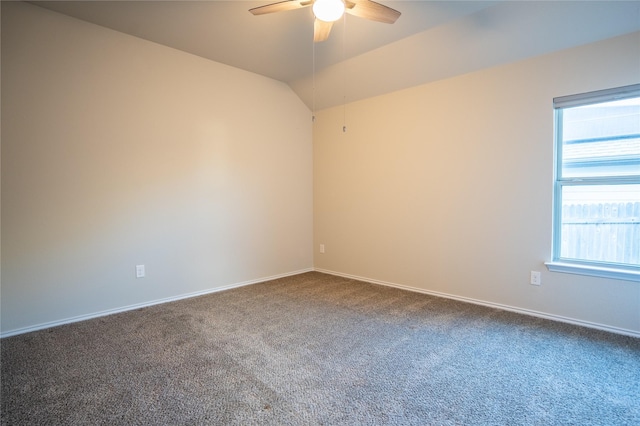 carpeted spare room with ceiling fan and vaulted ceiling