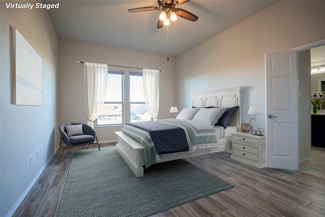 bedroom with ceiling fan, lofted ceiling, and light wood-type flooring