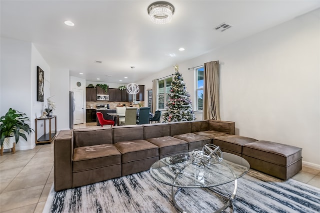 tiled living room featuring a notable chandelier