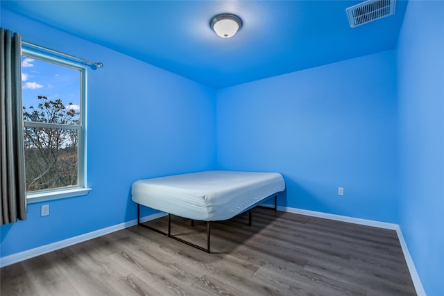 unfurnished bedroom featuring hardwood / wood-style flooring