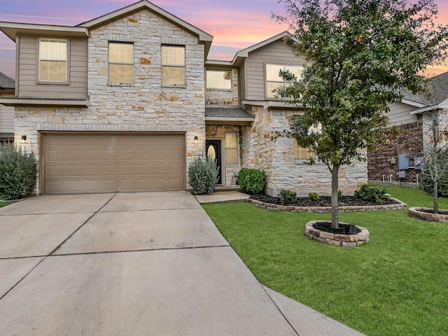 view of front of house with a garage and a yard