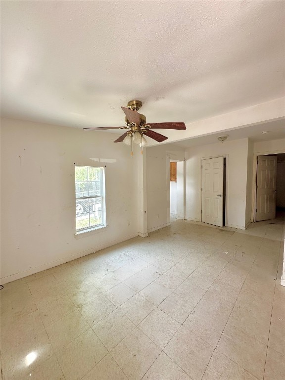 820 Chihuahua St, Lockhart, TX 78644 - empty room with a ceiling fan and a textured ceiling