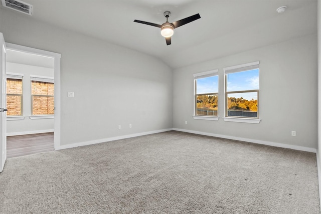 carpeted empty room featuring vaulted ceiling and ceiling fan