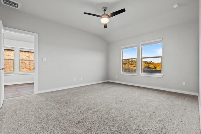 spare room featuring lofted ceiling, ceiling fan, and carpet flooring