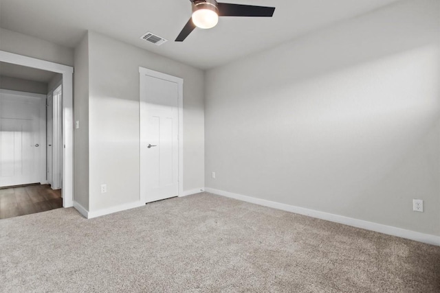 unfurnished bedroom with ceiling fan and carpet