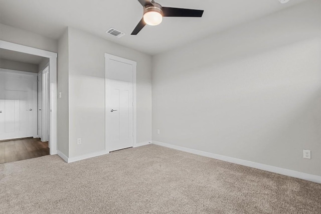 unfurnished bedroom featuring carpet, ceiling fan, and a closet