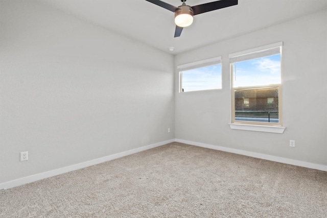 spare room featuring carpet flooring and ceiling fan