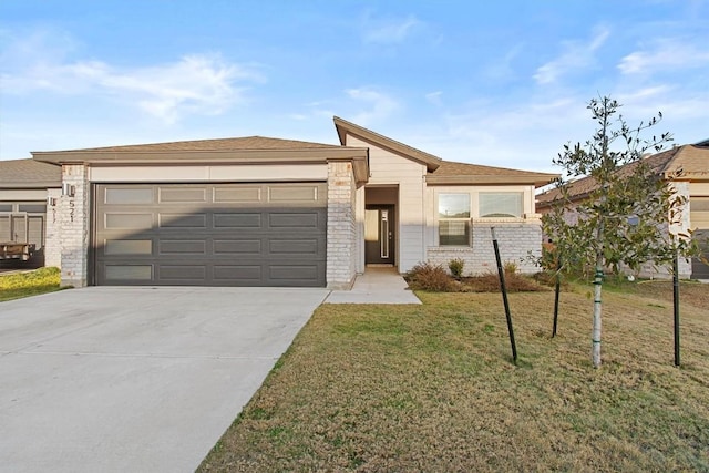 view of front of home featuring a garage and a front lawn