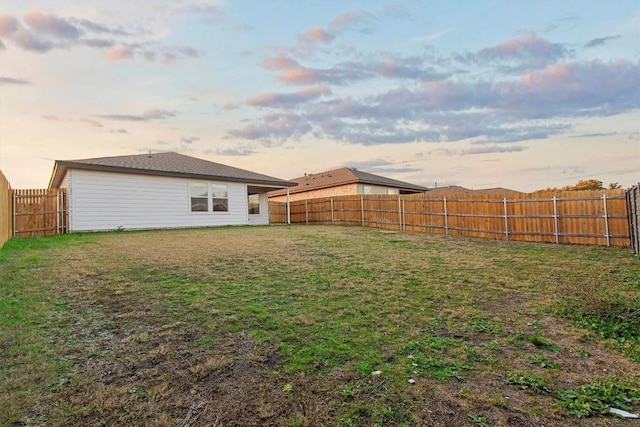 view of yard at dusk