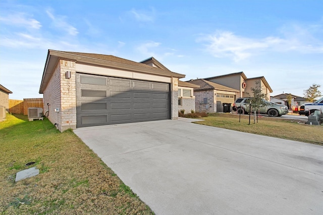 ranch-style home featuring a garage, a front yard, and central air condition unit