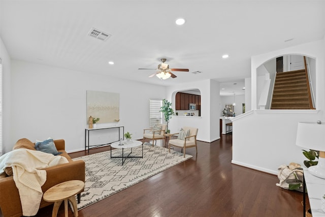 living room with dark hardwood / wood-style floors and ceiling fan