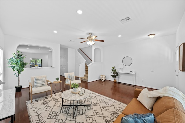 living room with wood-type flooring and ceiling fan