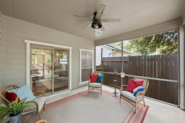 sunroom / solarium featuring ceiling fan