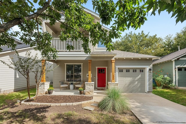 view of front of house with covered porch, a balcony, and a garage