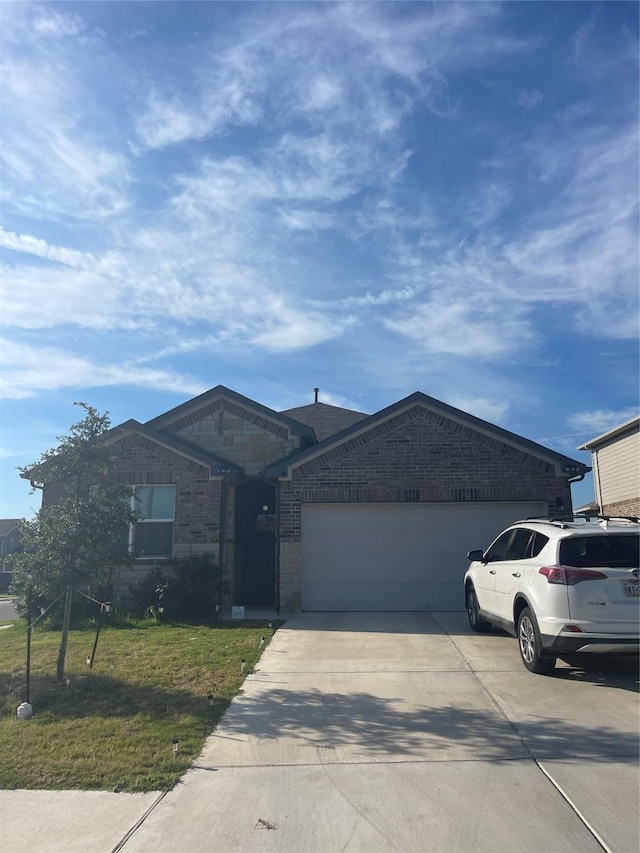 single story home featuring a front yard and a garage