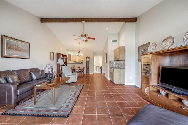 living room featuring baseboards, visible vents, dark tile patterned flooring, beam ceiling, and ceiling fan with notable chandelier
