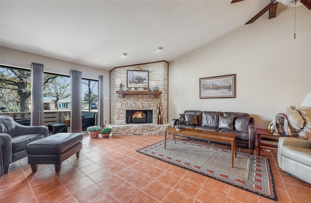 living room with tile patterned floors, ceiling fan, lofted ceiling, and a fireplace