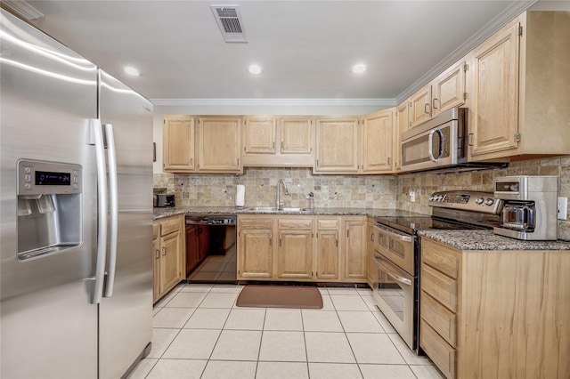 kitchen featuring light brown cabinets, light tile patterned floors, sink, and appliances with stainless steel finishes