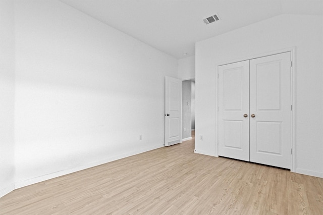 unfurnished bedroom with light hardwood / wood-style floors and a closet