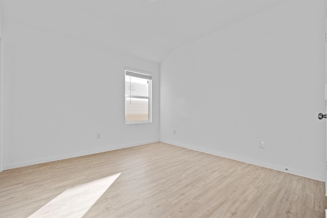 empty room with lofted ceiling and light wood-type flooring