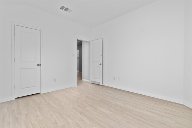 unfurnished room with light hardwood / wood-style floors