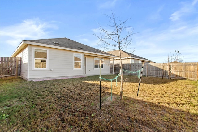 rear view of house with a lawn