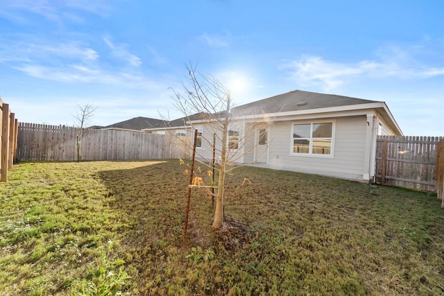 back of house with a lawn