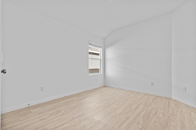 unfurnished room with lofted ceiling and light hardwood / wood-style flooring