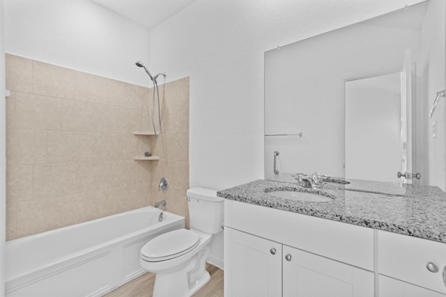 full bathroom with vanity, wood-type flooring, shower / bathtub combination, and toilet