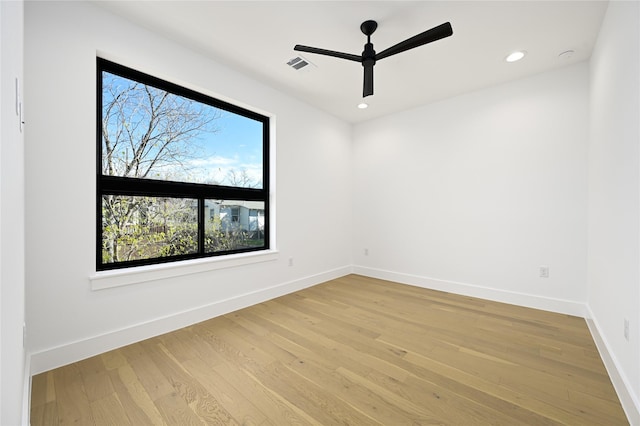 empty room with ceiling fan and light wood-type flooring