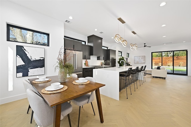 dining room featuring ceiling fan and light parquet floors